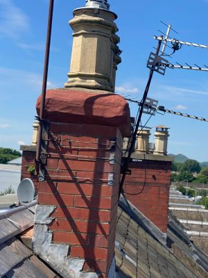 Weathered cope stone restoration with red dye mortar